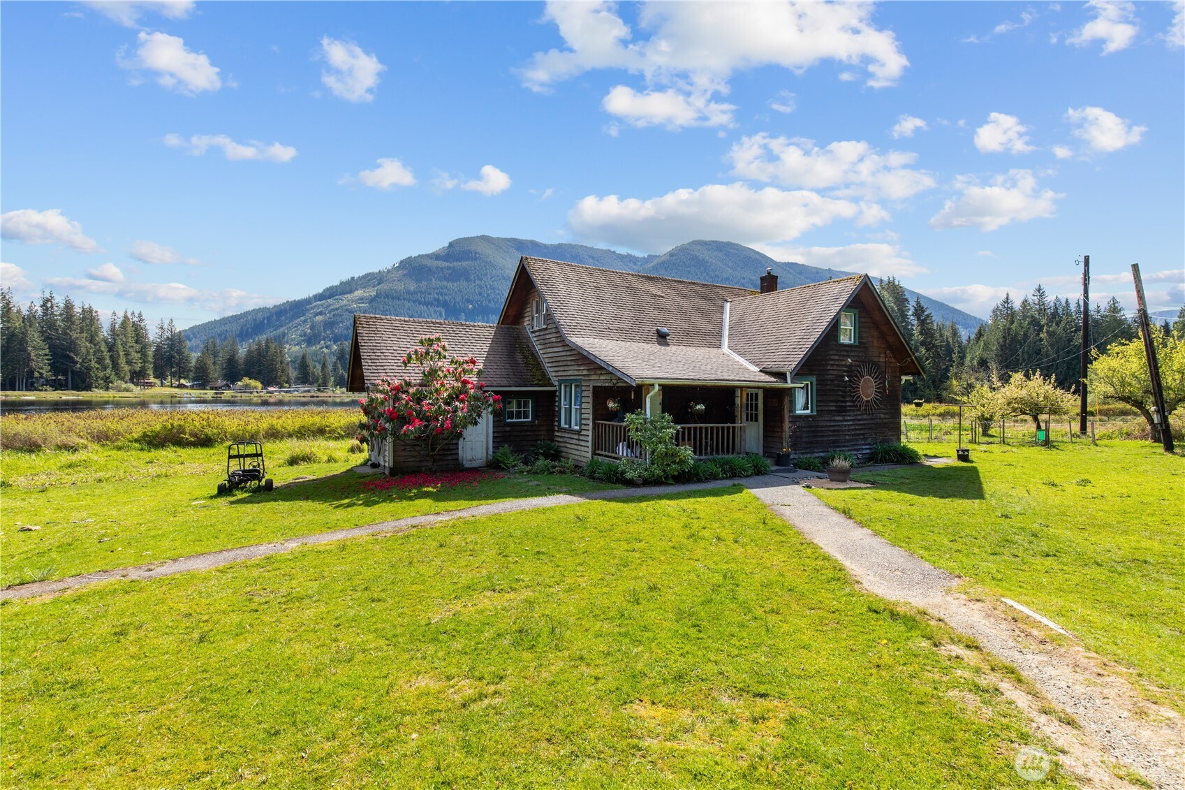 27525 West Lake Riley Road Arlington, WA 98223 - Photo 12 of 40 a front view of a house with swimming pool and a yard