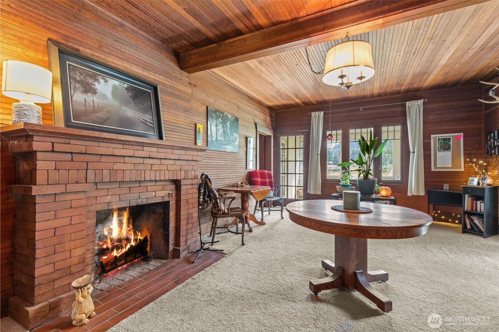 27525 West Lake Riley Road Arlington, WA 98223 - Photo 14 of 40 a living room with furniture a fireplace and a large window