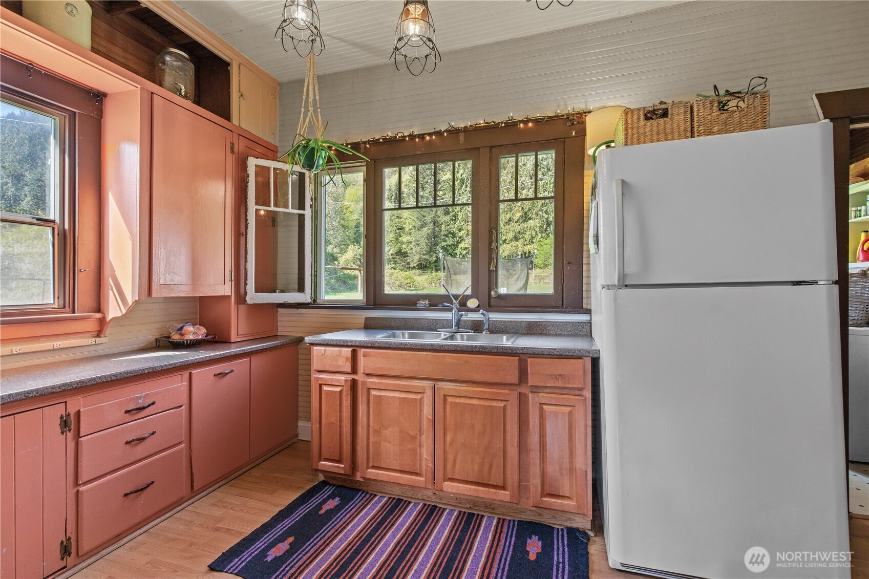 27525 West Lake Riley Road Arlington, WA 98223 - Photo 17 of 40 a kitchen with stainless steel appliances granite countertop a refrigerator a sink dishwasher a stove and white countertops with wooden floor