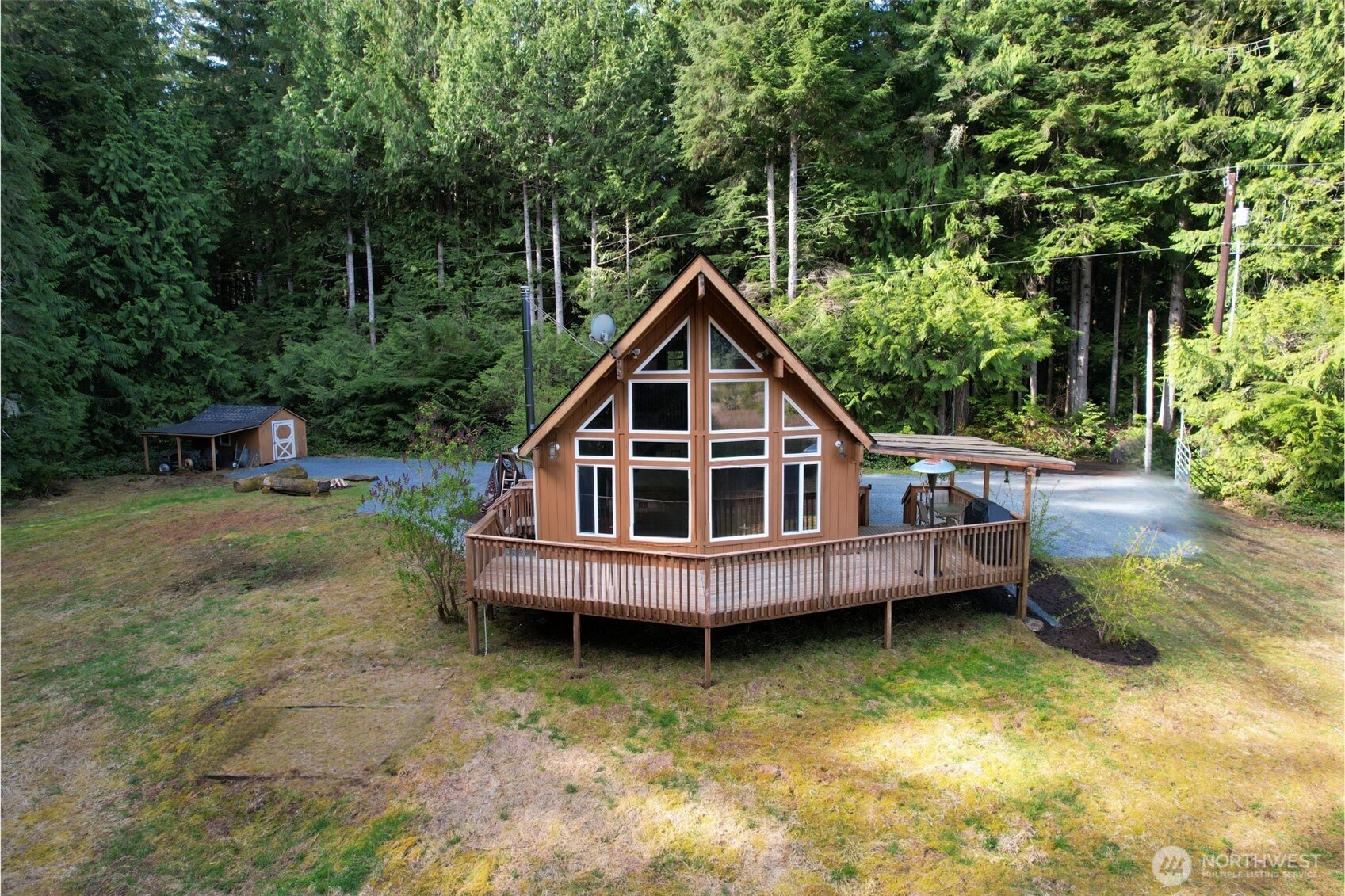 27525 West Lake Riley Road Arlington, WA 98223 - Photo 23 of 40 a view of a house with a wooden deck and a yard