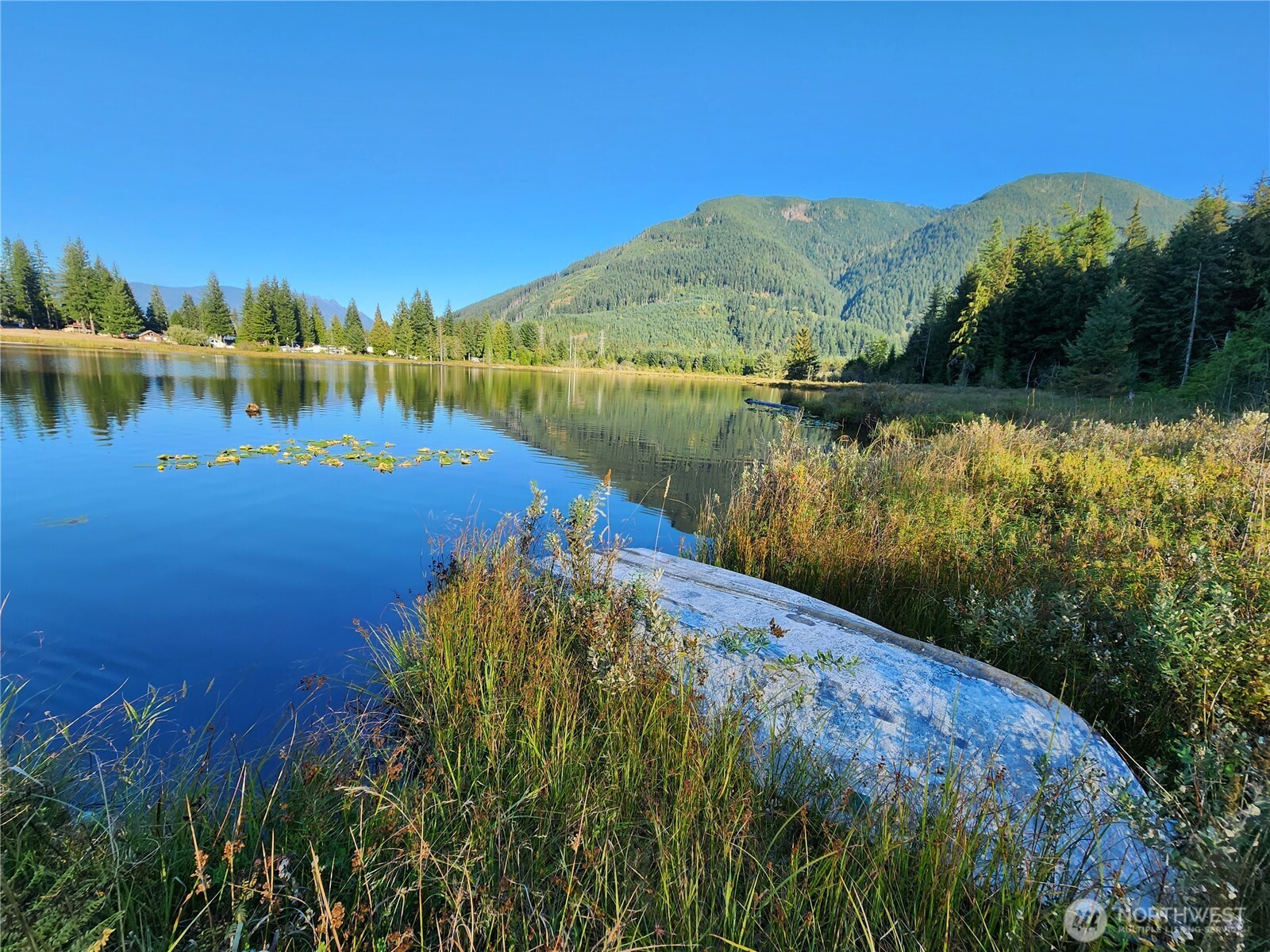 27525 West Lake Riley Road Arlington, WA 98223 - Photo 37 of 40 a view of a lake with a mountain in the background
