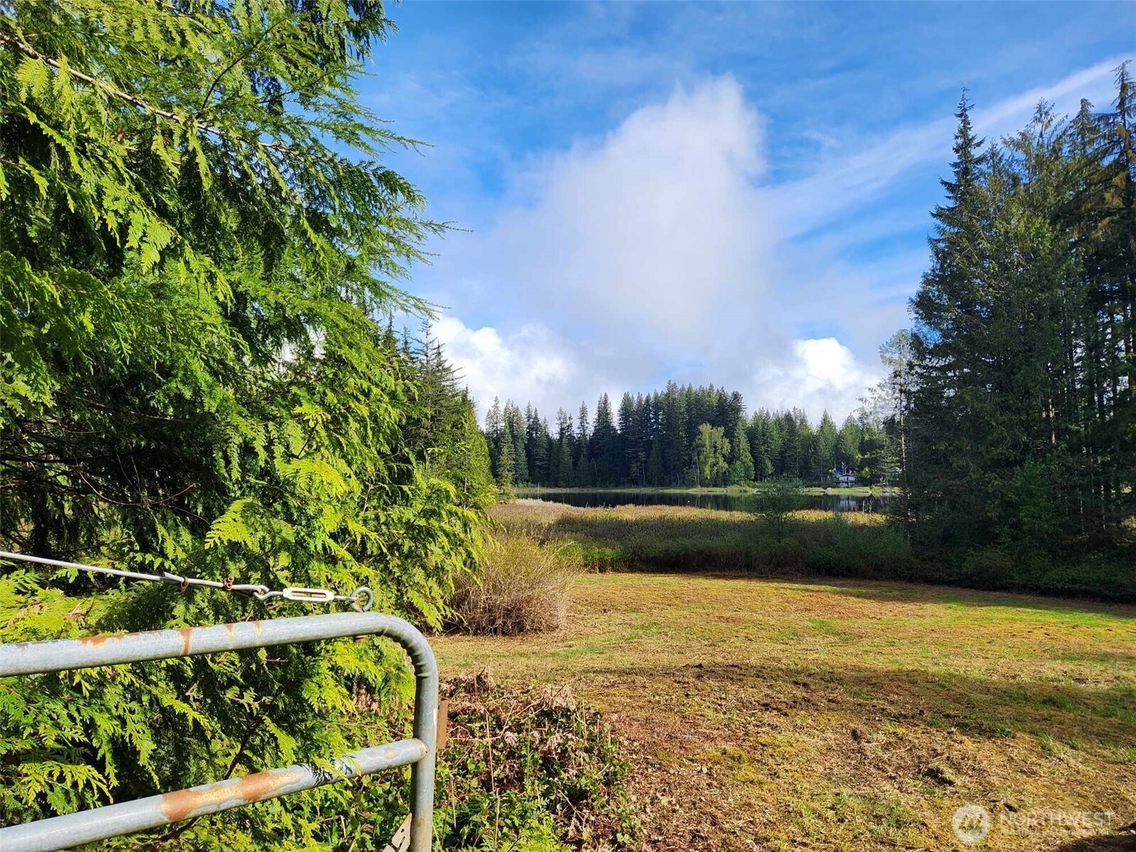 27525 West Lake Riley Road Arlington, WA 98223 - Photo 9 of 40 a view of a lake with a yard