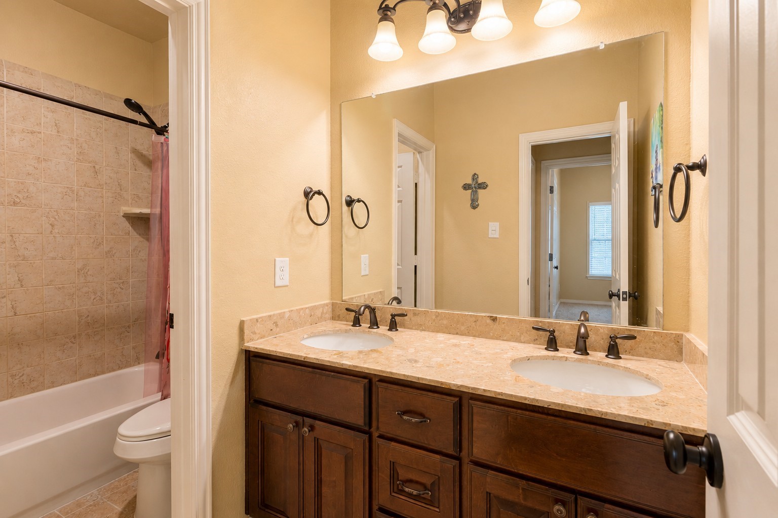 2326 Hamilton Pool Lane Friendswood, TX 77546 - Photo 32 of 49 a bathroom with a double vanity sink toilet mirror and bathtub