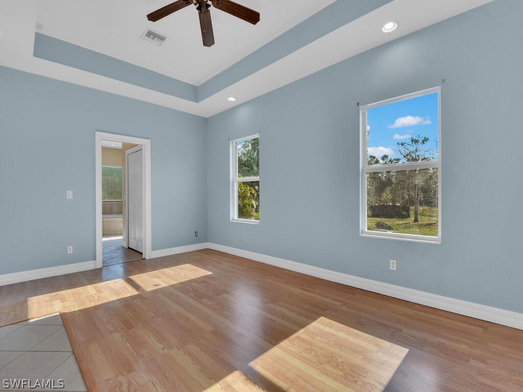 20401 Carter Road Estero, FL 33928 - Photo 17 of 42 a view of an empty room with window and wooden floor