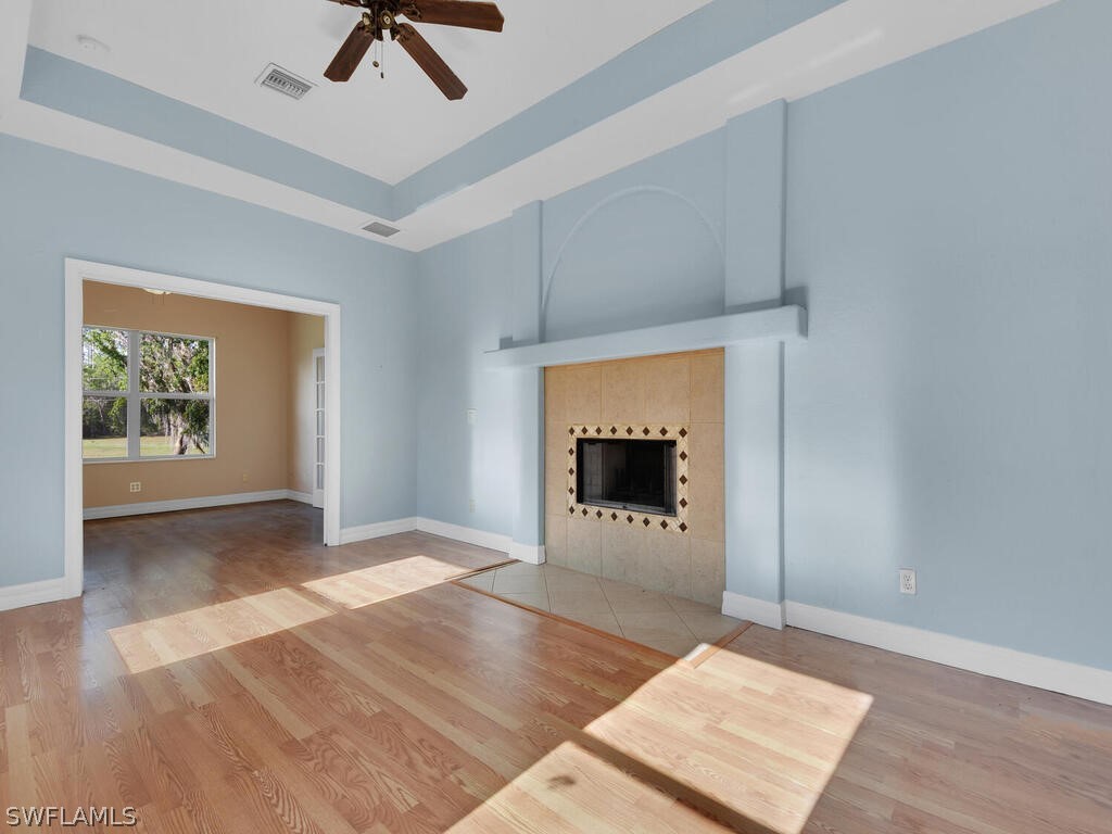 20401 Carter Road Estero, FL 33928 - Photo 18 of 42 an empty room with windows and fireplace