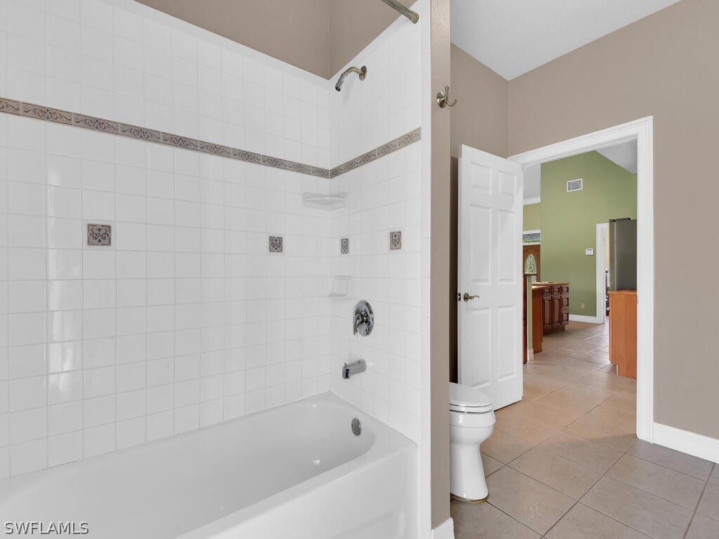 20401 Carter Road Estero, FL 33928 - Photo 22 of 42 a bathroom with a bathtub and a shower
