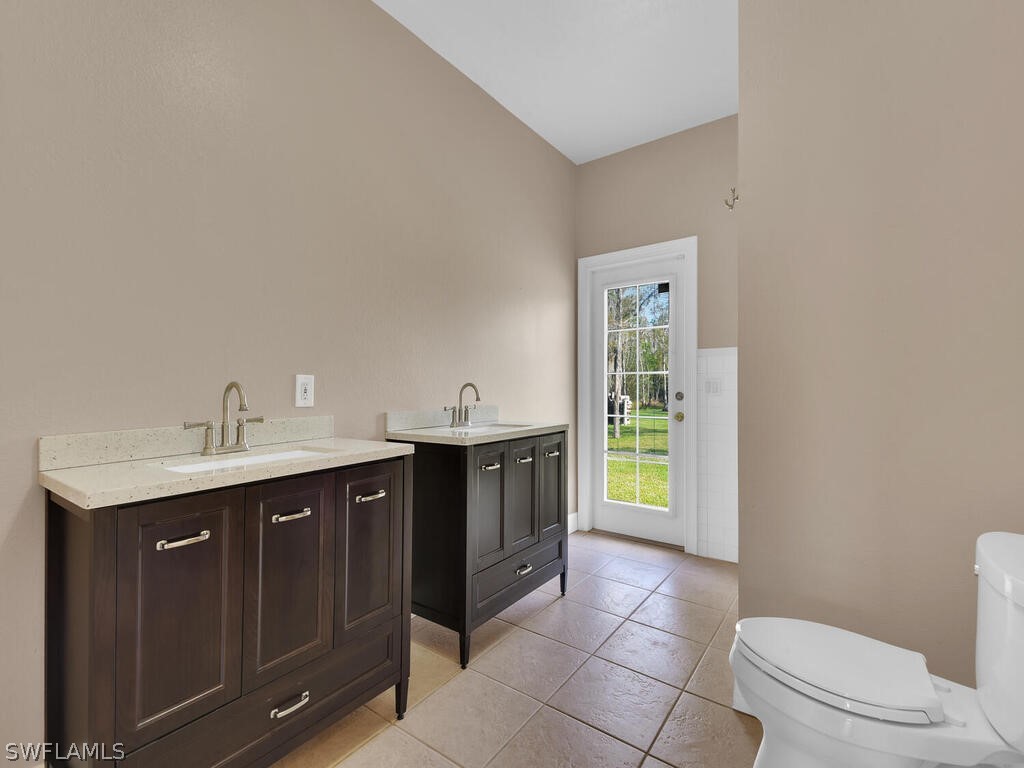20401 Carter Road Estero, FL 33928 - Photo 25 of 42 a bathroom with a sink vanity and toilet