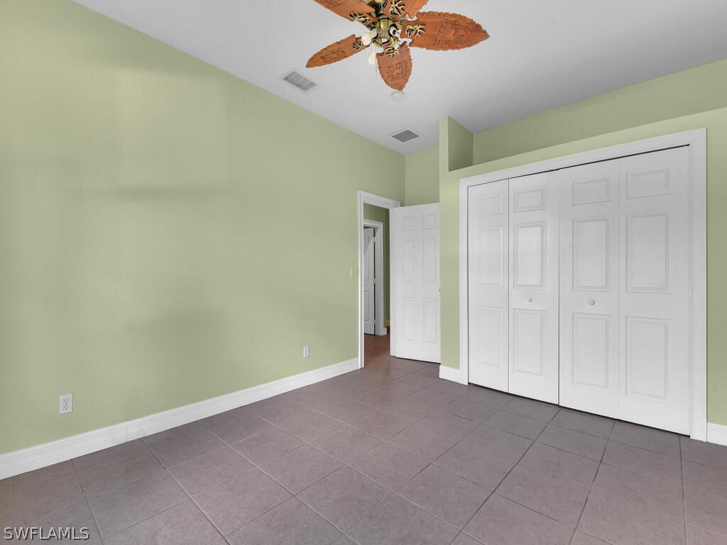 20401 Carter Road Estero, FL 33928 - Photo 27 of 42 an empty room and a chandelier fan