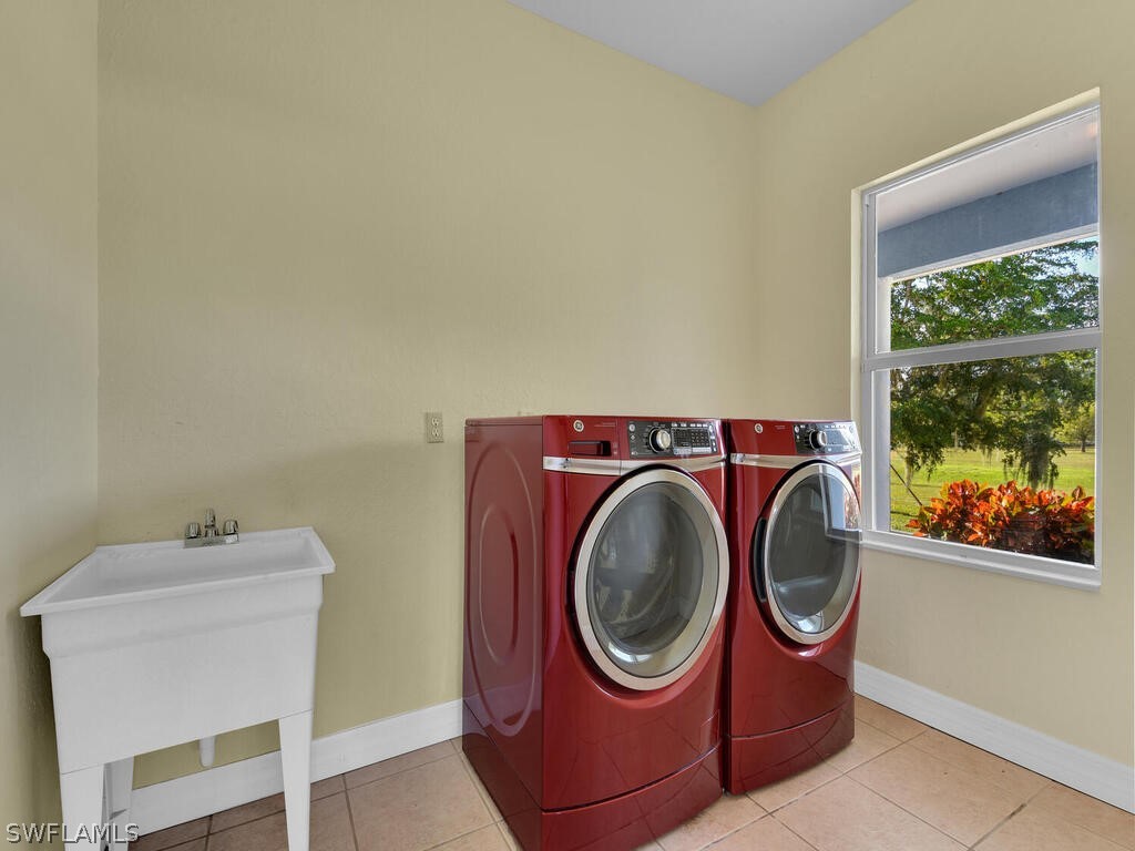 20401 Carter Road Estero, FL 33928 - Photo 28 of 42 a utility room with dryer and washer