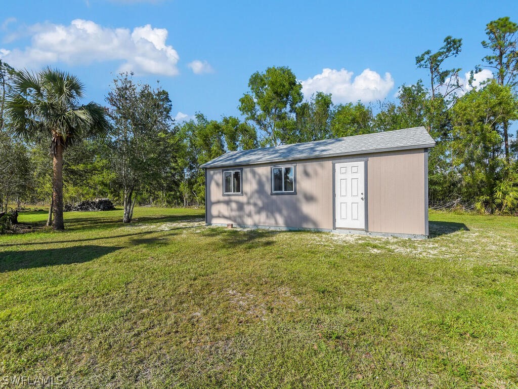 20401 Carter Road Estero, FL 33928 - Photo 32 of 42 a view of a house with backyard and garden