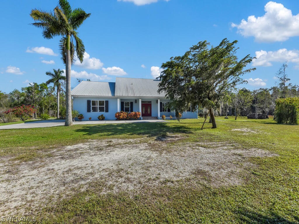 20401 Carter Road Estero, FL 33928 - Photo 4 of 42 a view of a house with a yard