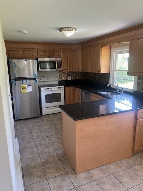 107 Valley Road Springfield, MA 01119 - Photo 3 of 14 a kitchen with stainless steel appliances granite countertop a stove a sink and a refrigerator