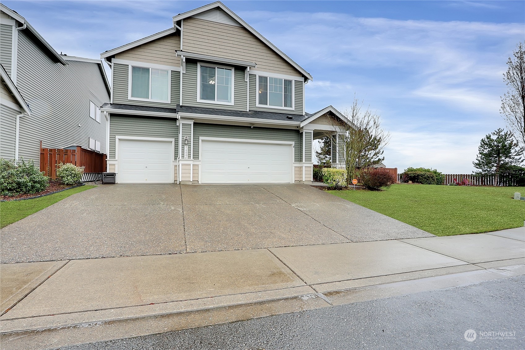 16004 24th Street East Lake Tapps, WA 98391 - Photo 1 of 32 a front view of a house with a yard and garage