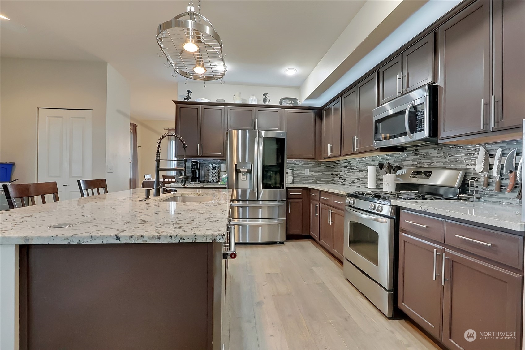 16004 24th Street East Lake Tapps, WA 98391 - Photo 11 of 32 a kitchen with stainless steel appliances granite countertop a sink a stove top oven and refrigerator