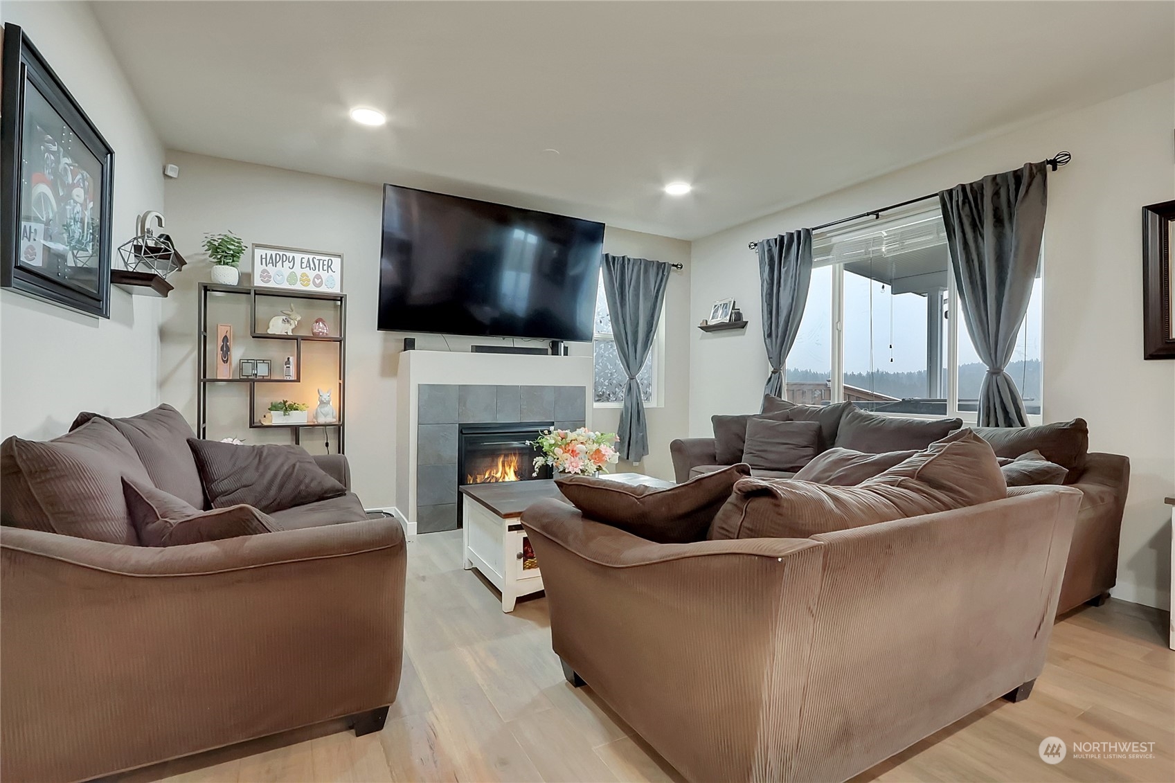 16004 24th Street East Lake Tapps, WA 98391 - Photo 12 of 32 a living room with fireplace furniture and a flat screen tv