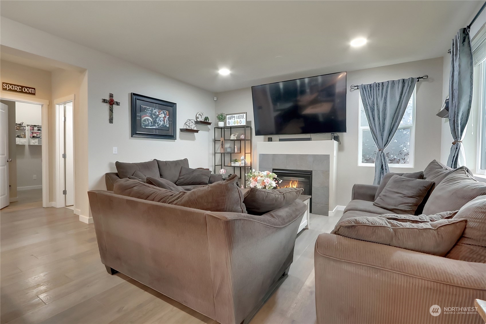 16004 24th Street East Lake Tapps, WA 98391 - Photo 13 of 32 a living room with furniture a flat screen tv and a fireplace