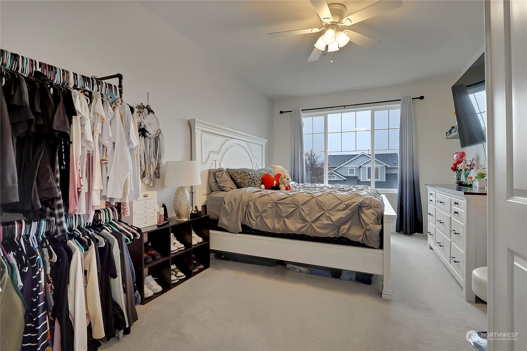 16004 24th Street East Lake Tapps, WA 98391 - Photo 17 of 32 a bedroom with a bed and a chandelier