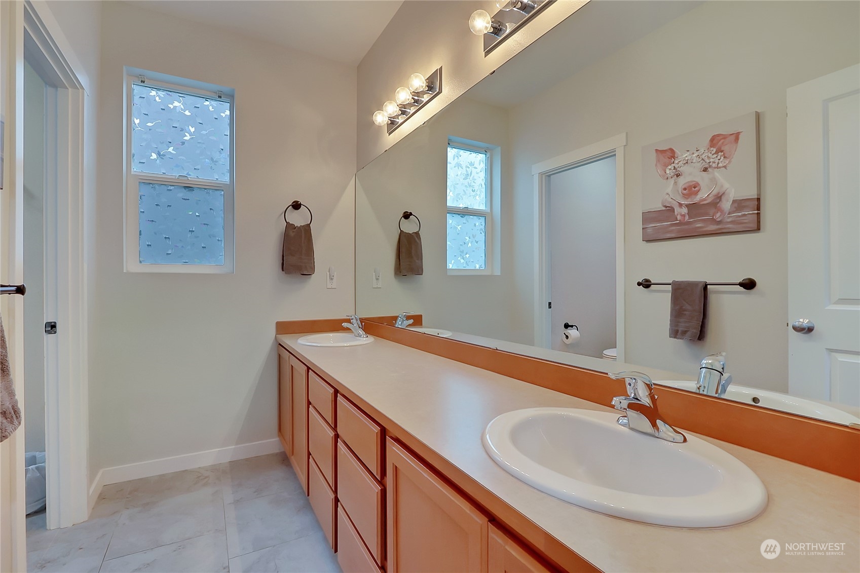 16004 24th Street East Lake Tapps, WA 98391 - Photo 20 of 32 a bathroom with double vanity sinks a mirror and a shower