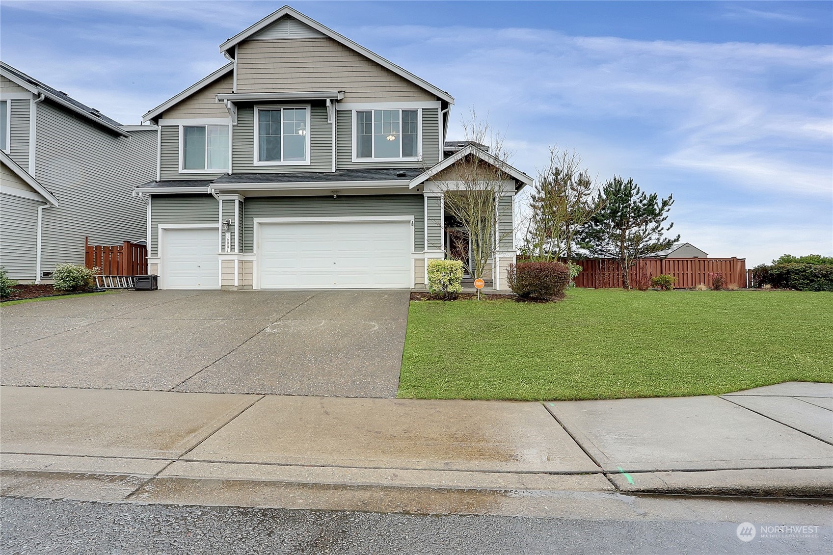 16004 24th Street East Lake Tapps, WA 98391 - Photo 2 of 32 a front view of a house with a yard and garage