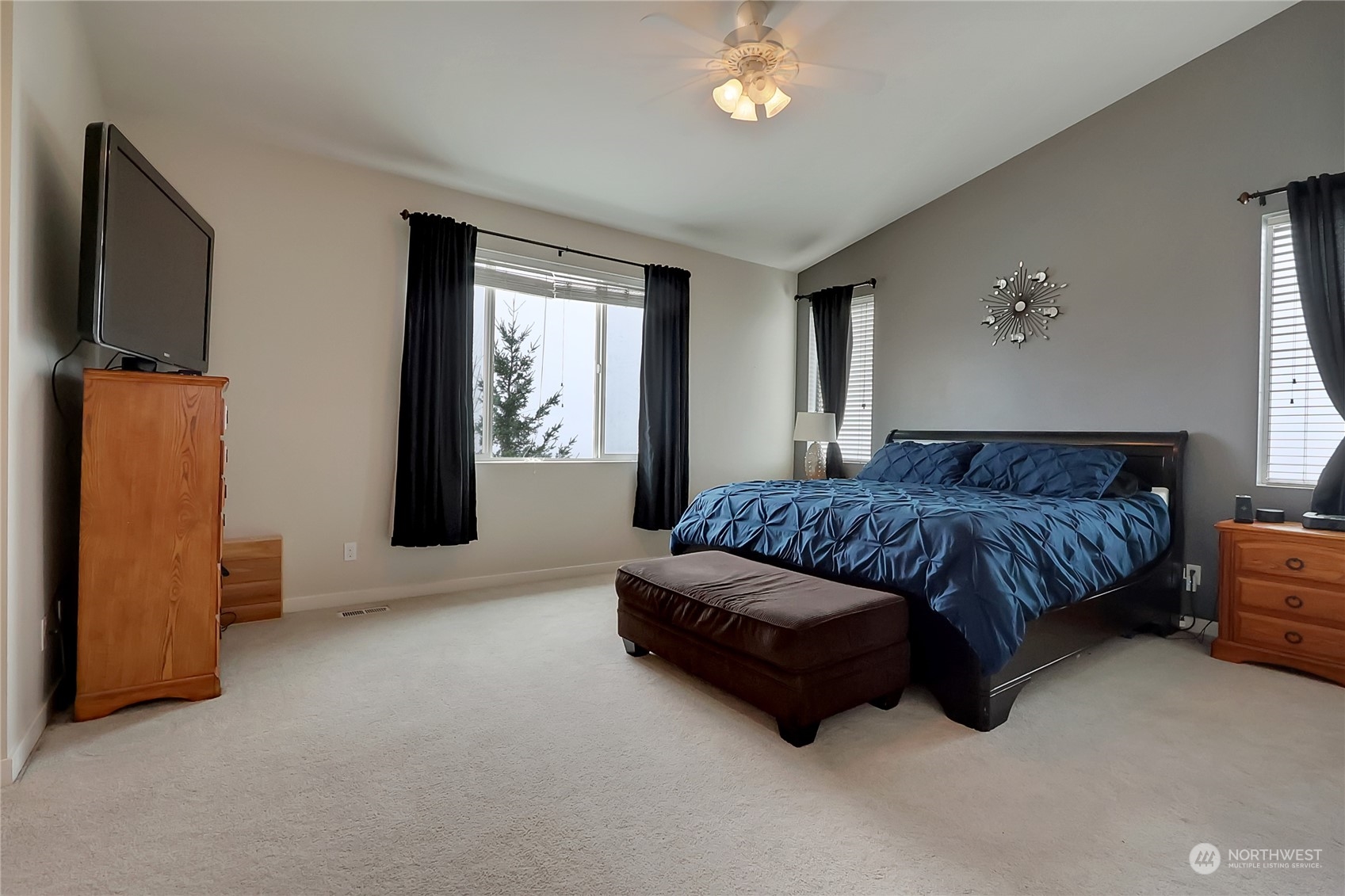 16004 24th Street East Lake Tapps, WA 98391 - Photo 22 of 32 a spacious bedroom with a bed and a flat screen television