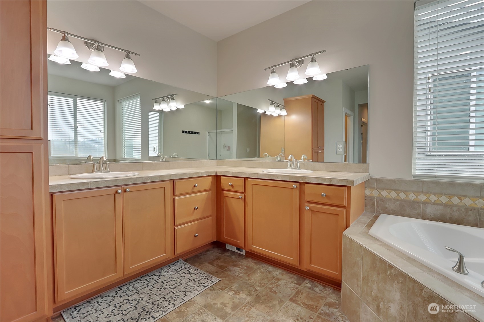 16004 24th Street East Lake Tapps, WA 98391 - Photo 25 of 32 a spacious bathroom with a granite countertop sink a large mirror a bathtub and window