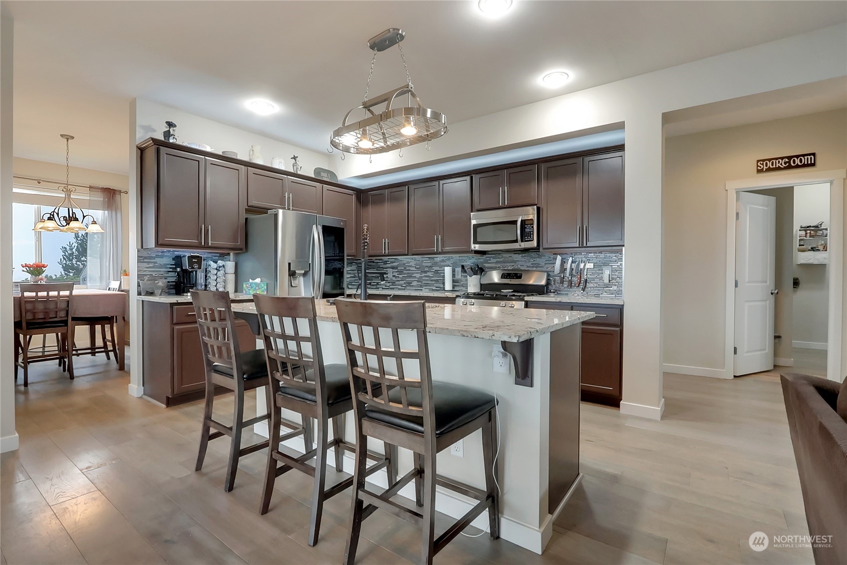 16004 24th Street East Lake Tapps, WA 98391 - Photo 10 of 32 a kitchen with stainless steel appliances kitchen island granite countertop a refrigerator and a stove top oven