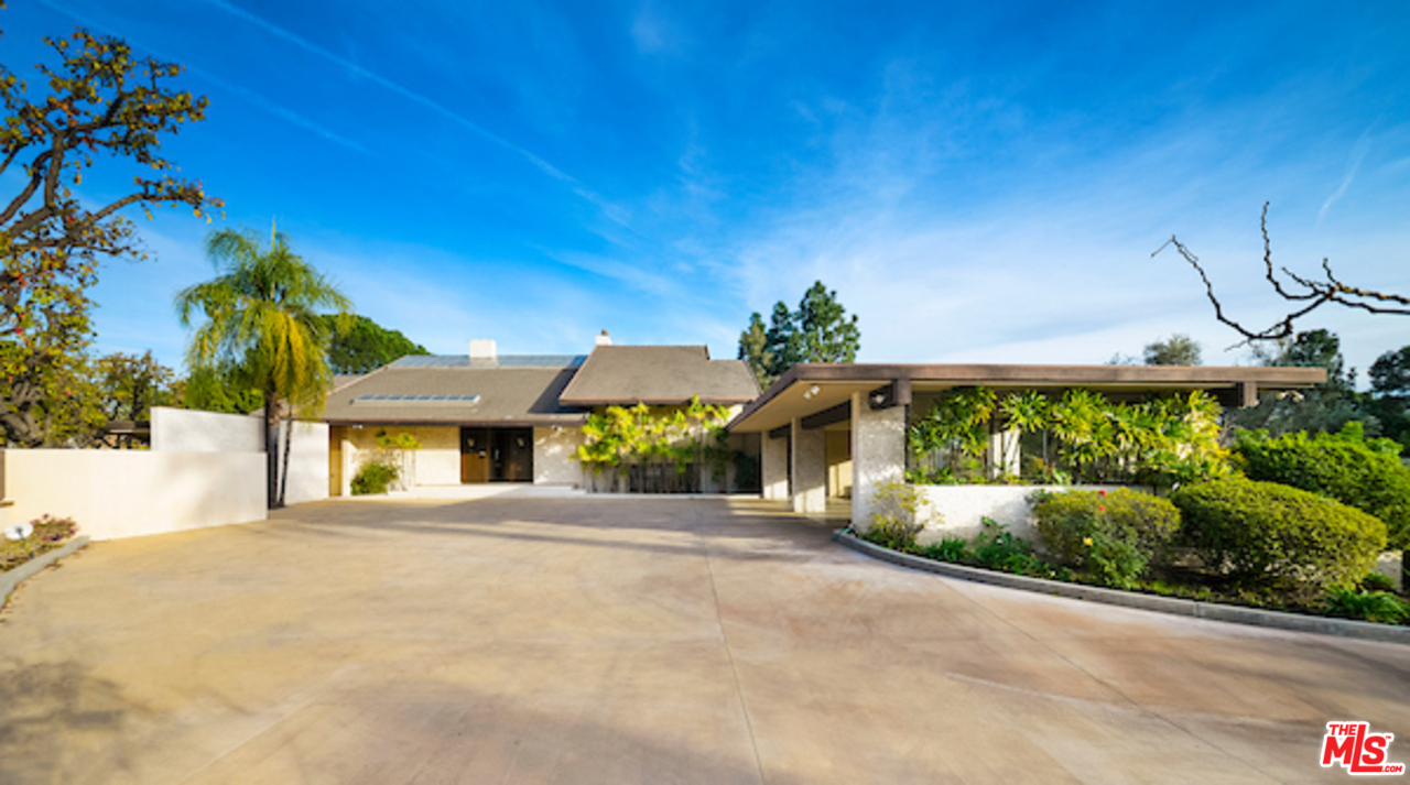 984 North Alpine Drive Beverly Hills, CA 90210 - Photo 3 of 8 a front view of a house with a yard and potted plants