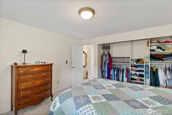 a view of a bedroom with a furniture and closet