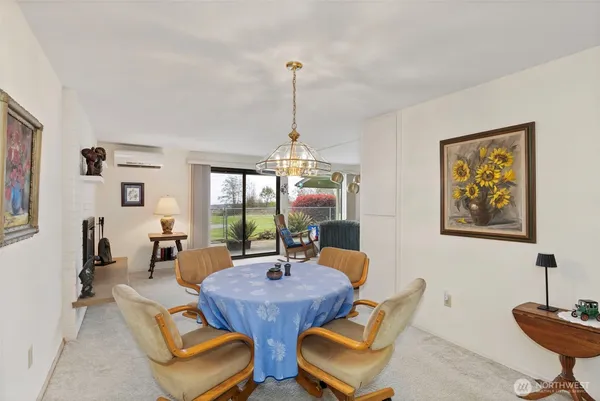 a dining room with furniture a rug and a chandelier