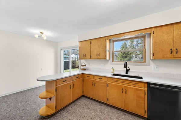 a kitchen with a sink cabinets and window