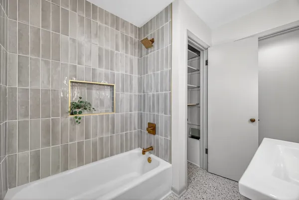 a bathroom with a bathtub and shower