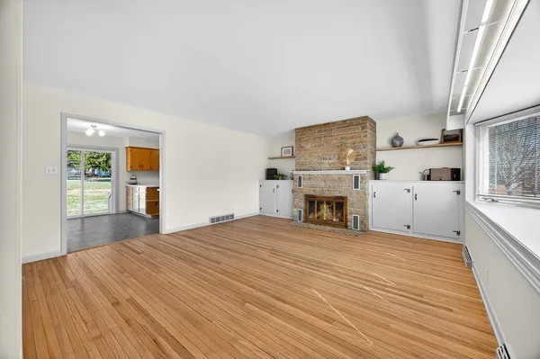 a spacious bedroom with a bed and a fireplace