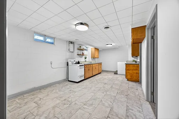 a view of a kitchen with a sink and a stove top oven