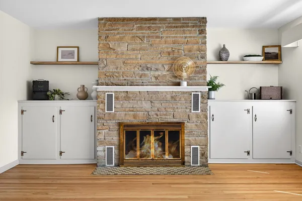 a view of kitchen with granite countertop cabinets and fireplace