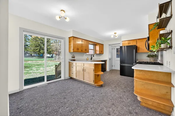a view of kitchen with furniture and refrigerator