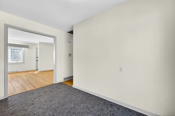 a view of hallway with wooden floor