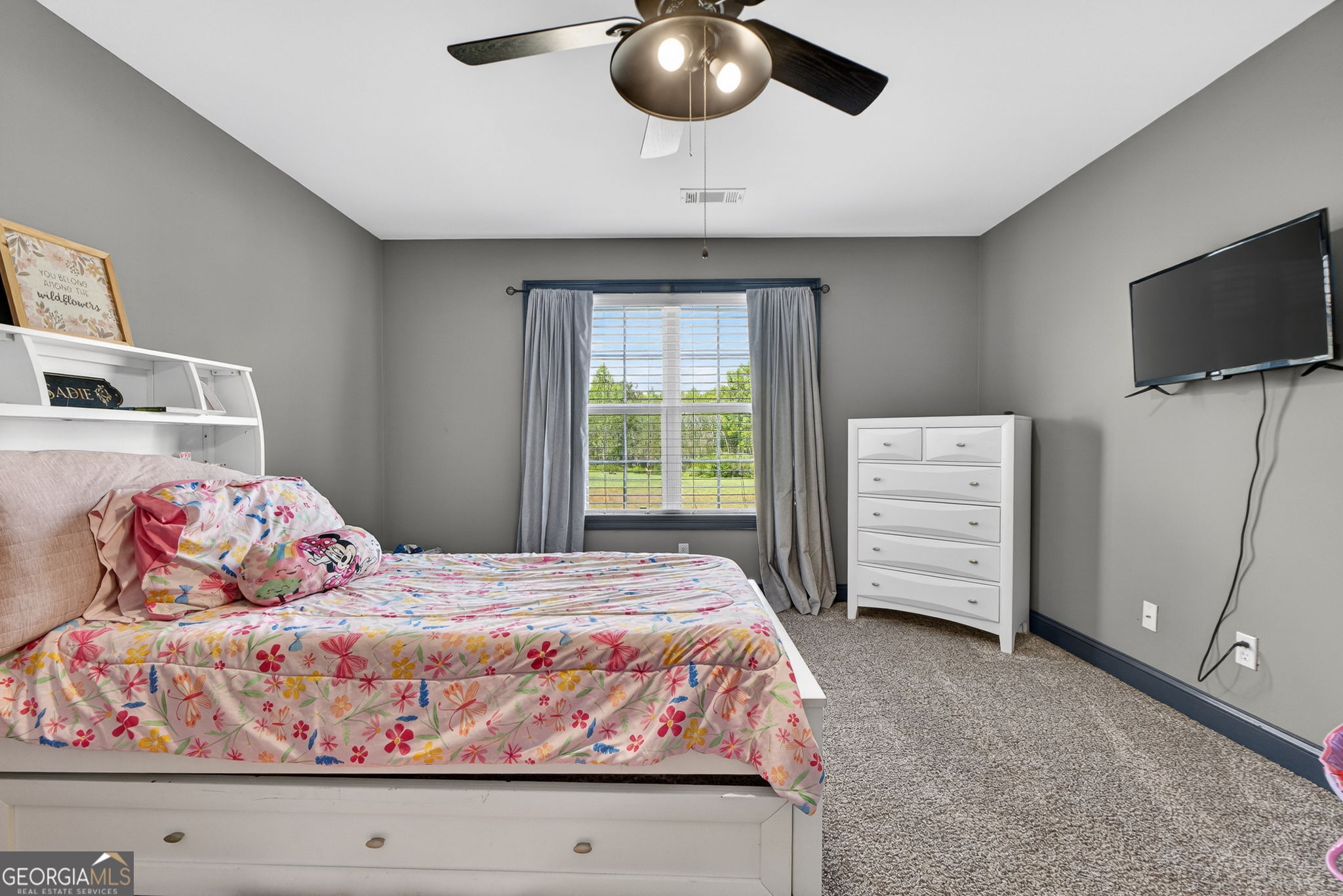 130 Derby Drive Forsyth, GA 31029 - Photo 70 of 97 a bedroom with a bed and flat screen tv