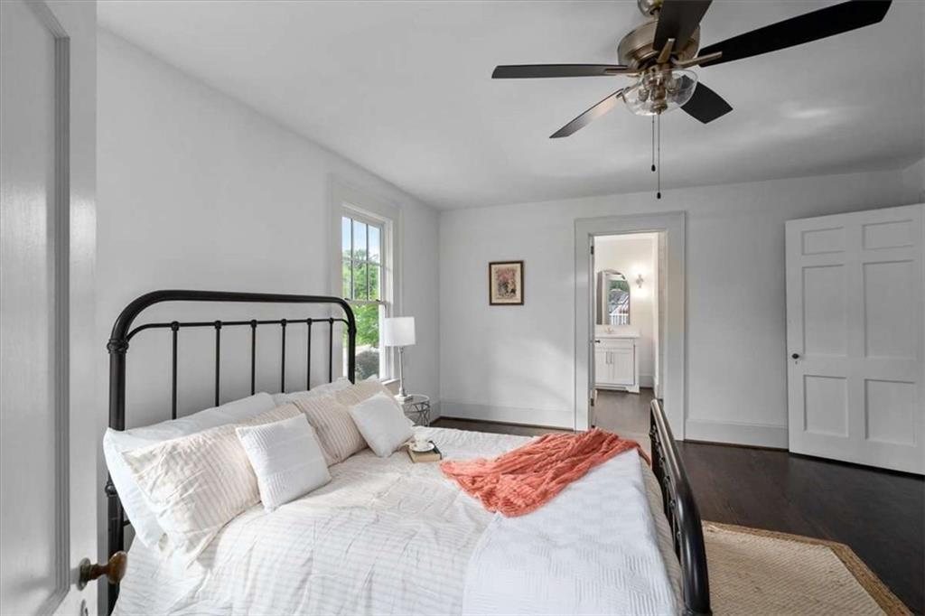 6104 Floyd Street Northeast Covington, GA 30014 - Photo 20 of 53 a bedroom with a large bed and a chandelier