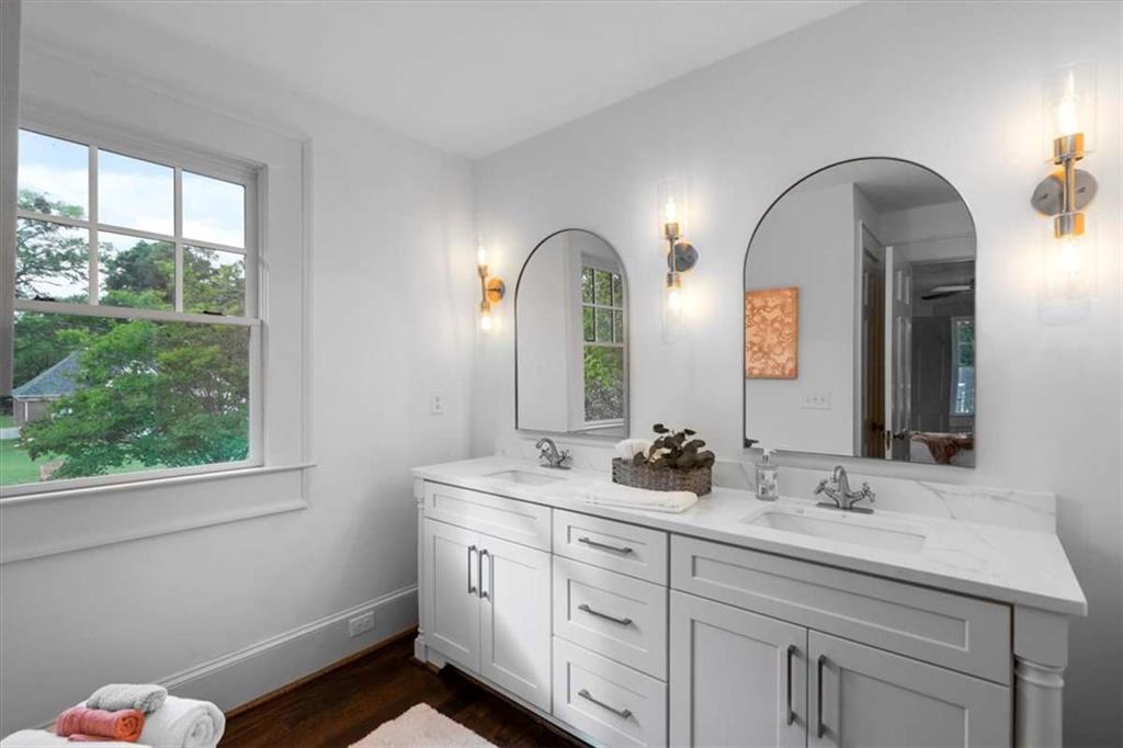 6104 Floyd Street Northeast Covington, GA 30014 - Photo 21 of 53 a bathroom with a double vanity sink and a with a mirror