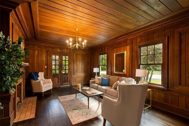 a living room with furniture and large windows