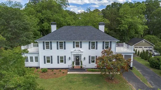 an aerial view of a house with a yard