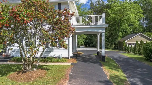 a backyard of a house with table and chairs