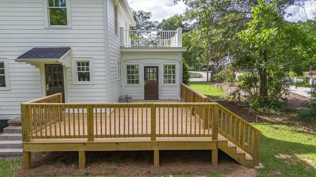 a backyard of a house with table and chairs