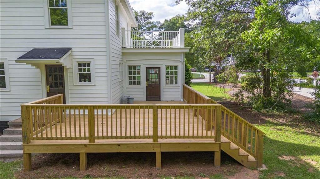 6104 Floyd Street Northeast Covington, GA 30014 - Photo 43 of 53 a view of a house with a small yard and wooden fence