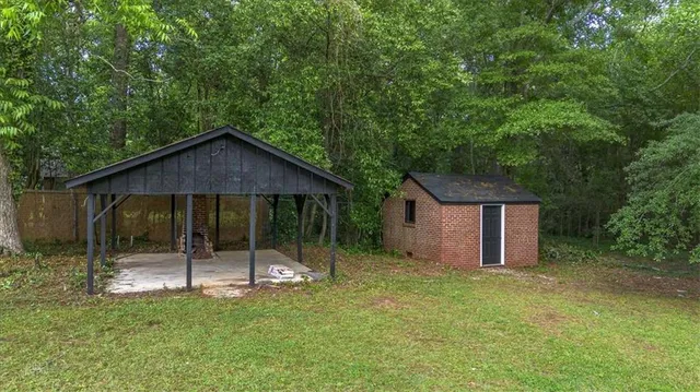 a view of a house with a yard and sitting area
