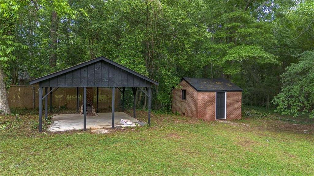 6104 Floyd Street Northeast Covington, GA 30014 - Photo 45 of 53 a backyard of a house with table and chairs