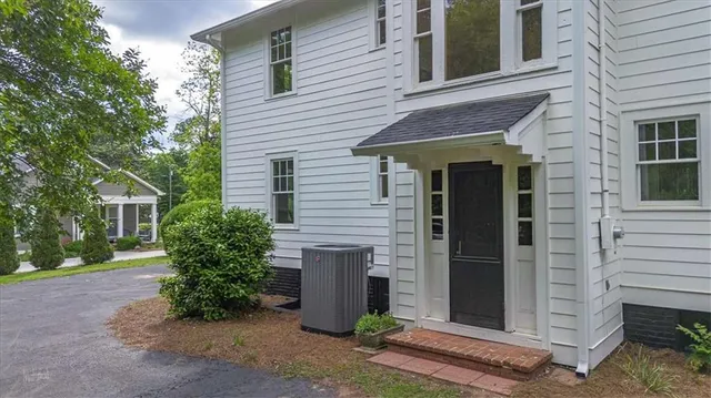 a view of a house with a yard and sitting area