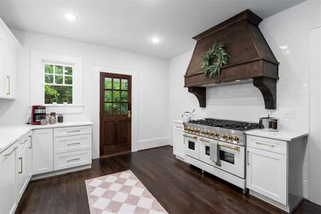 a kitchen with a sink stove and cabinets