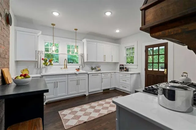 a kitchen with a sink window and cabinets