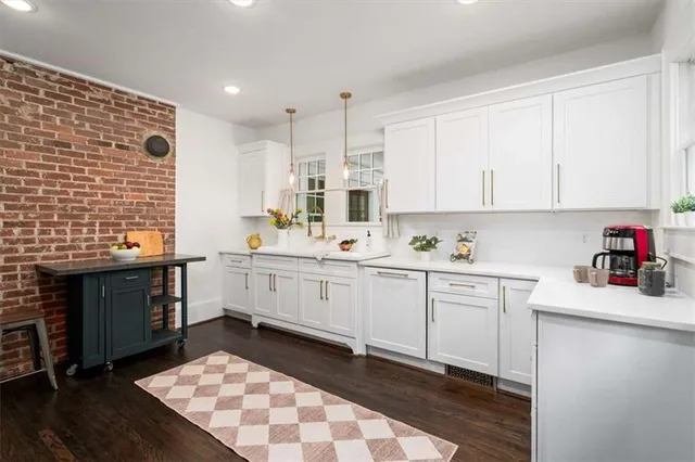 a kitchen with a sink cabinets and window